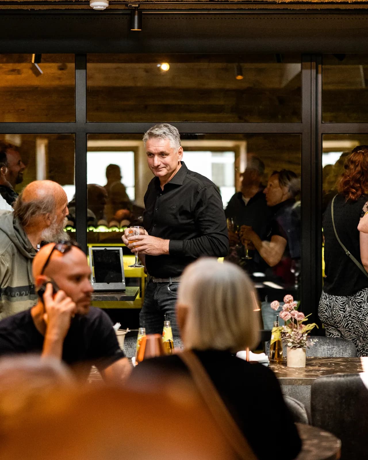 Gasten met een glas in de hand tijdens een borrel bij De Haas